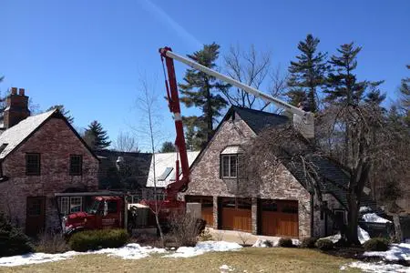 A crane is in front of a house